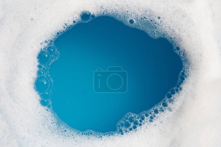 Photo for Detergent foam bubble on water. Blue background, Soap sud - Royalty Free Image