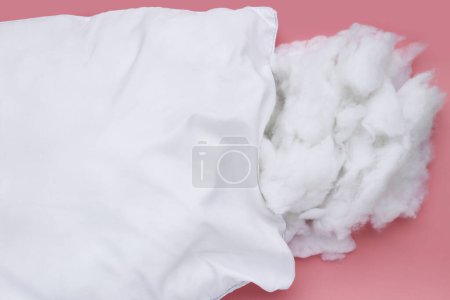 White pillow with polyester stable fiber on pink background.
