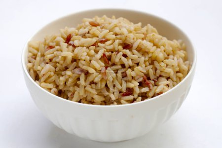 Cooked brown rice in white bowl