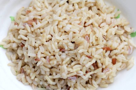 Cooked brown rice in white bowl