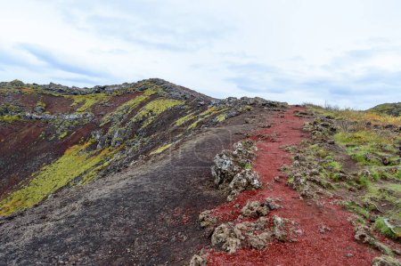 Hiking on top of the Kerid volcanic lake in Iceland
