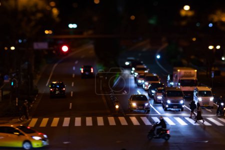 Photo for A night timelapse miniature traffic jam at the city crossing in Tokyo. High quality photo. Nakano district Higashinakano Tokyo Japan 10.11.2022 Here is an electric quarter in Tokyo. It is center of - Royalty Free Image