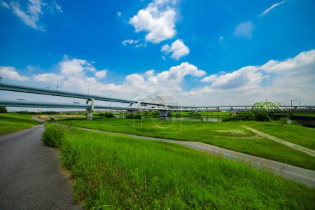 Photo for A traffic jam at the urban street near the river wide shot. High quality photo. Adachi district Kouhoku Tokyo Japan 06.29.2023 Here is near Arakawa river in Tokyo. - Royalty Free Image