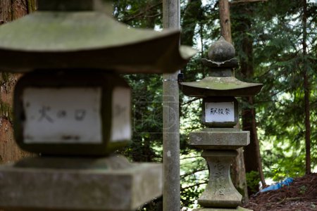 Old Stone lanterns at Japanese old shrine at the countryside. High quality photo. Agatsuma district Nakanojo Gunma Japan 07.20.2023 This shrine is called SUWA SHRINE. Here is a countryside in Gunma.
