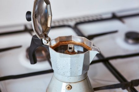 Photo for A geyser coffee maker on a gas stove produces a portion of coffee - Royalty Free Image