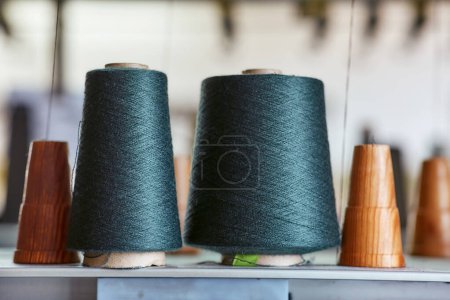 Photo for Two bobbins with industrial threads on cones - Royalty Free Image