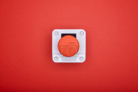 Photo for Single emergency button at the red background at the top view - Royalty Free Image