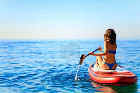 Photo for Woman paddling on sup board with mountains on background. - Royalty Free Image