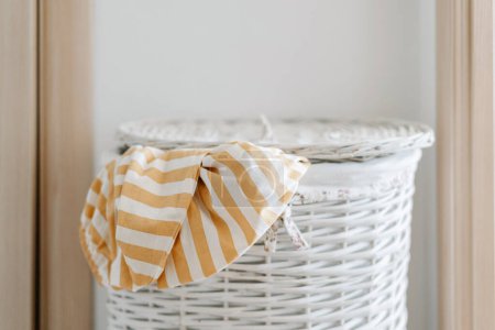 Photo for Striped white yellow long-sleeved t-shirt in laundry basket. High quality photo - Royalty Free Image