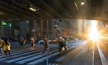Foto de Sunlight shining on people walking across a busy street crosswalk at Grand Central Station in Manhattan New York City NYC - Imagen libre de derechos