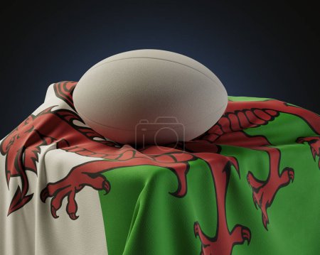 Téléchargez les photos : Un ballon de rugby régulier reposant sur un drapeau du Pays de Galles drapé sur un socle sur un fond de studio isolé - rendu 3D - en image libre de droit