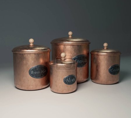 Téléchargez les photos : A set of for copper kitchen snack containers for laels representing nuts, candy, snacks and cookies on a background - 3D render - en image libre de droit
