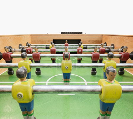 Téléchargez les photos : Une table de baby-foot vintage en bois avec figurines détaillées en métal jaune et rouge sur fond de studio blanc isolé - rendu 3D - en image libre de droit