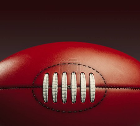 Téléchargez les photos : A generic unbranded aussie rules football ball on an isolated dark studio background - 3D render - en image libre de droit