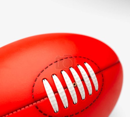 Téléchargez les photos : A generic unbranded aussie rules football ball on an isolated studio background - 3D render - en image libre de droit
