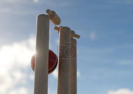 Foto de Una bola de cricket rojo golpeando grillos de madera con las fianzas de desalojo en un fondo cielo día - 3D render - Imagen libre de derechos
