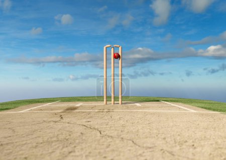 Une boule de cricket rouge frappant des guichets de cricket en bois avec des bails délogés sur un fond de ciel de jour - rendu 3D