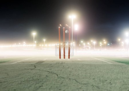 Photo for A white cricket ball striking orange electronic cricket wickets with dislodging bails and illuminating LED lights on a night sky background - 3D render - Royalty Free Image