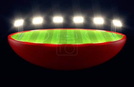 Photo for An ausralian rules  ball split in half revealing a marked green grass football pitch with goals at night under illuminated floodlights - 3D render - Royalty Free Image