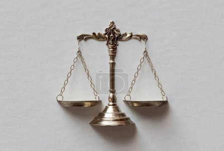 Ornate brass justice scales embedded on a paper background - 3D render