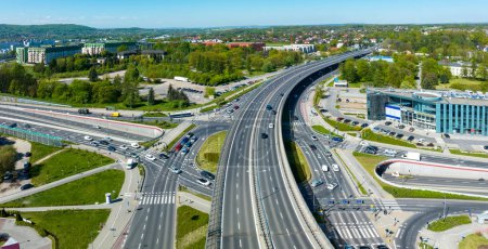 Photo for Multilevel city highway junction in Krakow, Poland. One highway on the top level, the second one in the tunnel, the turnaround with traffic lights and zebra crossings on the middle level. Aerial view - Royalty Free Image