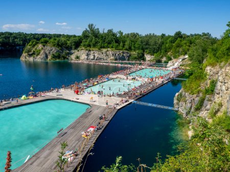 Photo for Krakow, Poland - July 8, 2023: Swimming and paddling pools on a Zakrzowek lake with steep cliffs in place of former flooded limestone quarry. Newly opened recreational place with a crowd of people - Royalty Free Image