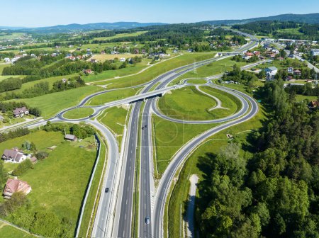 Photo for New highway junction in Poland on national road no 7, E77, called Zakopianka.  Overpass crossroad with traffic circles, slip ramps and viaducts near Rabka. Road E77 to Slovakia to the right - Royalty Free Image