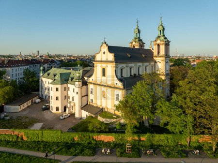 Skalka. St. Stanislaus church and Paulinite monastery in Krakow, Poland. Historic burial place of distinguished Poles. Aerial view. Spring, sunset light. Promenade along the wall with climbing vine