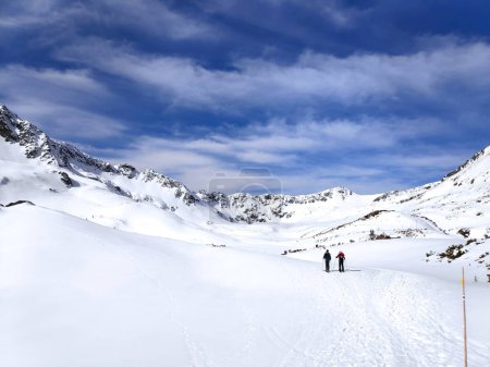 Photo for Beautiful panorama in winter Tatry mountains, Five Lakes Valley, Dolina Pieciu Stawow with two man skitouring. Phone photo - Royalty Free Image