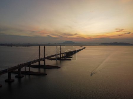 Photo for Aerial view morning sunrise of Penang Bridge. Fisherman boat sail at sea - Royalty Free Image