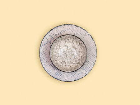 Photo for Decorated empty plate, seen from above, on beige background. Sharp and precise details create an elegant and clean composition. - Royalty Free Image