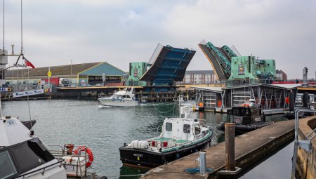 Foto de Poole lifting bridge in raised position as boats pass through in Poole, Dorset, UK on 13 February 2023 - Imagen libre de derechos