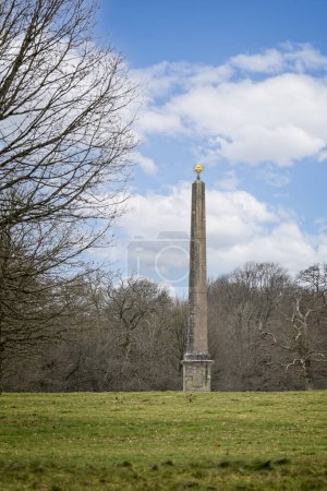 Photo for Obelisk with golden sun disk in the gardens of Stourhead House in Wiltshire, UK on 20 January 2024 - Royalty Free Image