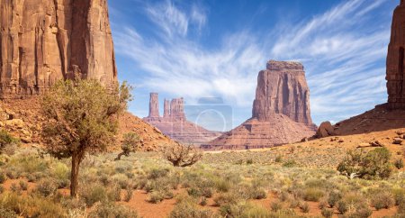 Large red sandstone buttes and spire formations in Monument  Valley from the valley floor, Arizona, USA on 22 April 2024