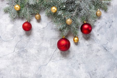 Téléchargez les photos : Composition festive de Noël et du Nouvel An avec branches de sapin des neiges, boules de Noël rouges et dorées sur fond de marbre - en image libre de droit