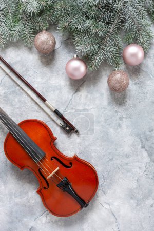 Photo for Old violin and fir-tree branches with Christmas decor. Christmas, New Year's concept. Top view, close-up - Royalty Free Image
