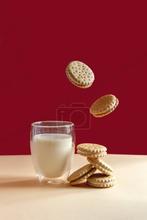 Photo for Glass of milk and flying round homemade cookies - Royalty Free Image