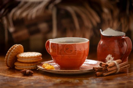 Photo for Cozy autumn photo with a cup of coffee with crispy homemade cookies and cinnamon on the background of a warm folded fringed plaid - Royalty Free Image