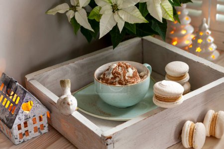 Photo for Festive Christmas New Year still life composition hot drink mug with coffee cream and cinnamon, french macaroon, macaron - Royalty Free Image