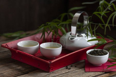 Photo for Traditional green tea ceremony set - white teapot and cups on the tra - Royalty Free Image