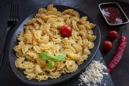 Photo for Uncooked Creste di Gallo pasta and ingredients for it cookin - Royalty Free Image