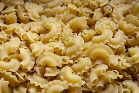 Photo for Uncooked Creste di Gallo pasta and ingredients for it cookin - Royalty Free Image