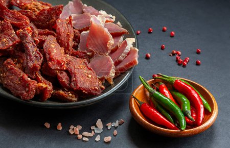 Photo for Dry beef meat jerky biltong with hot pepper chilli and spice - Royalty Free Image