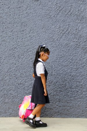 4-jährige Latina Brünette Mädchen mit Brille, Uniform und Rucksack geht zur Schule diese zurück zur Schule