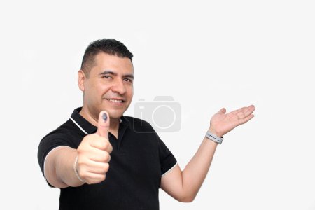 Photo for Dark-skinned Latino adult man shows his inked thumb after exercising his free and secret vote in Mexico - Royalty Free Image