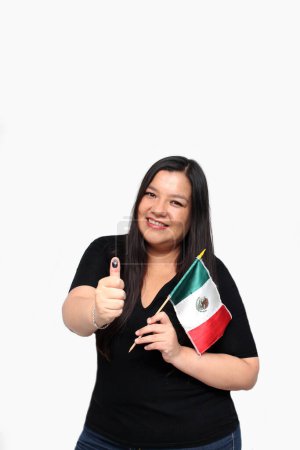 Latin adult woman shows her thumb inked with indelible electoral ink after exercising her right to free and secret voting