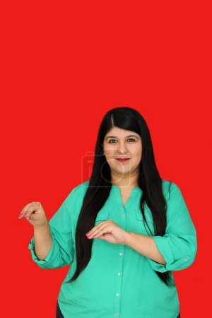 Photo for 30-year-old Latina woman communicates with people with hearing disabilities in an inclusive way using Mexican Sign Language - Royalty Free Image