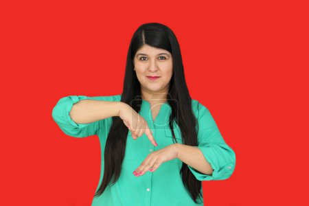 Photo for 30-year-old Latina woman communicates with people with hearing disabilities in an inclusive way using Mexican Sign Language - Royalty Free Image