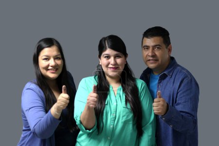 Two Latino women and a man show their thumb inked with indelible electoral ink after voting in the election