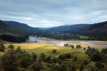 Autumn view of the river valley surrounded by mountains. Cairngorms, Highlands, Scotland.